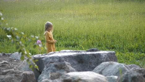 medium shot of young girl feeling sad and depressed at field at summer day