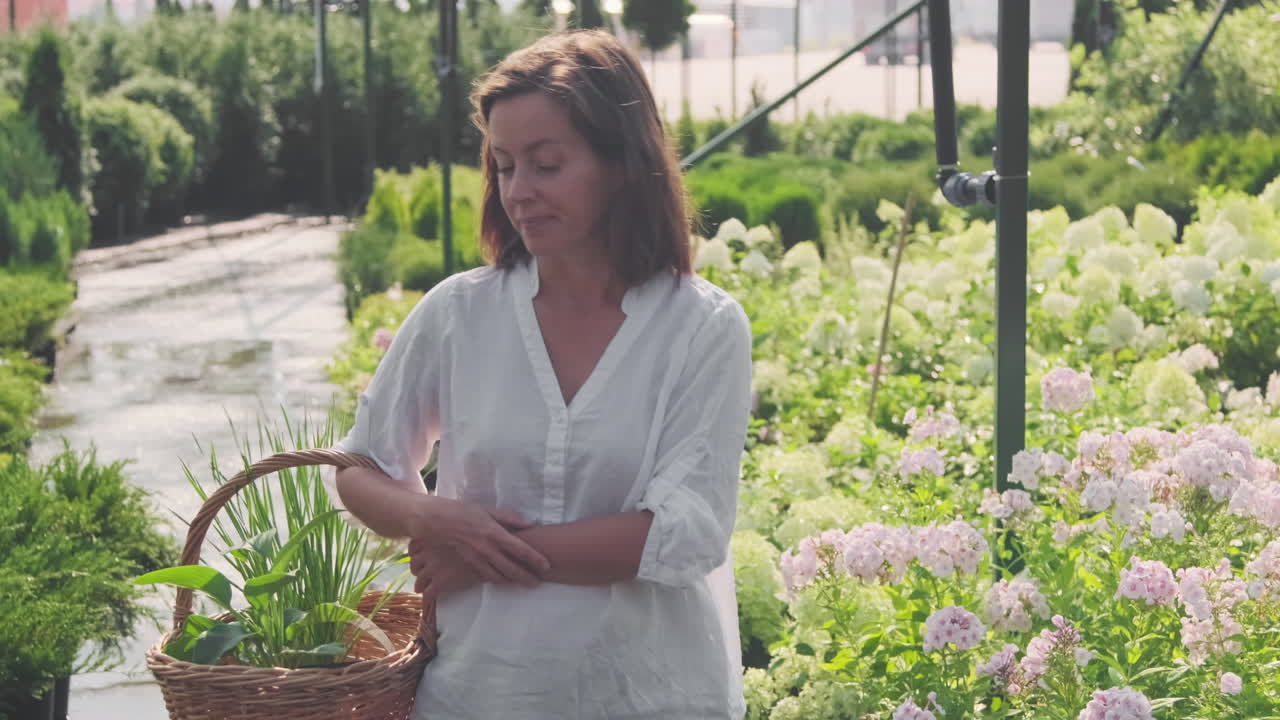 Woman shopping for plants in garden center