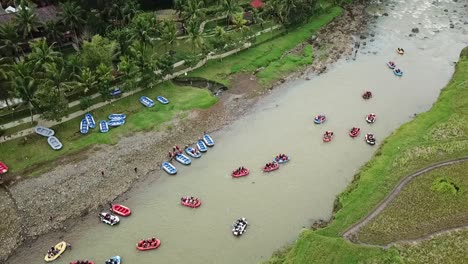 aerial view of many rafting boats ply the river water