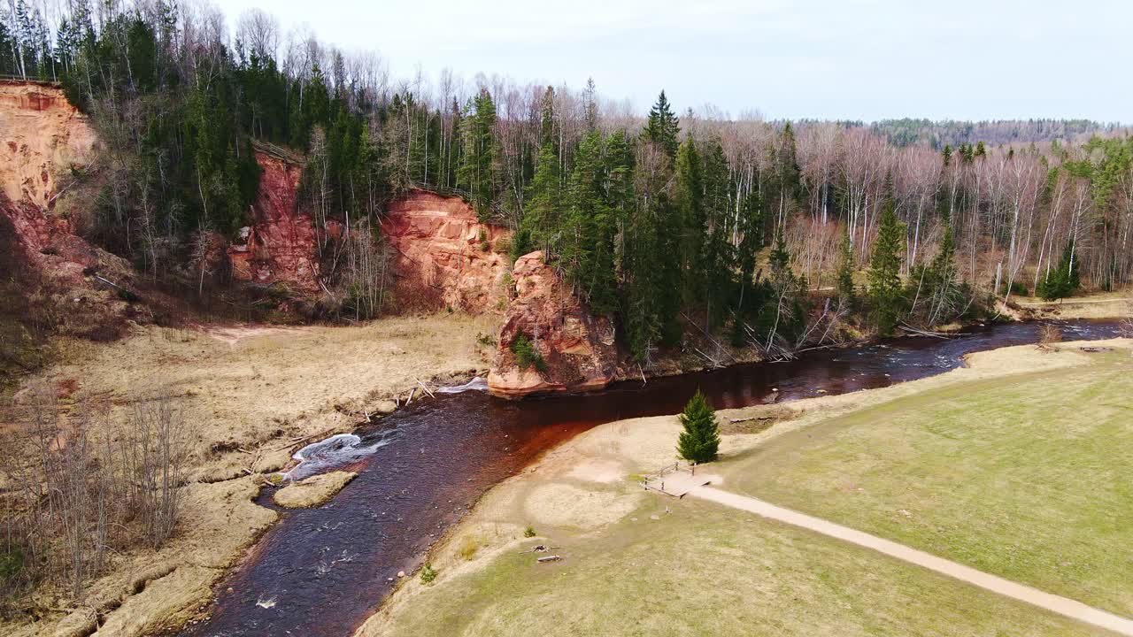 Latvian sandstone formations by river on bright spring day, Amata, Zvārtes Rock