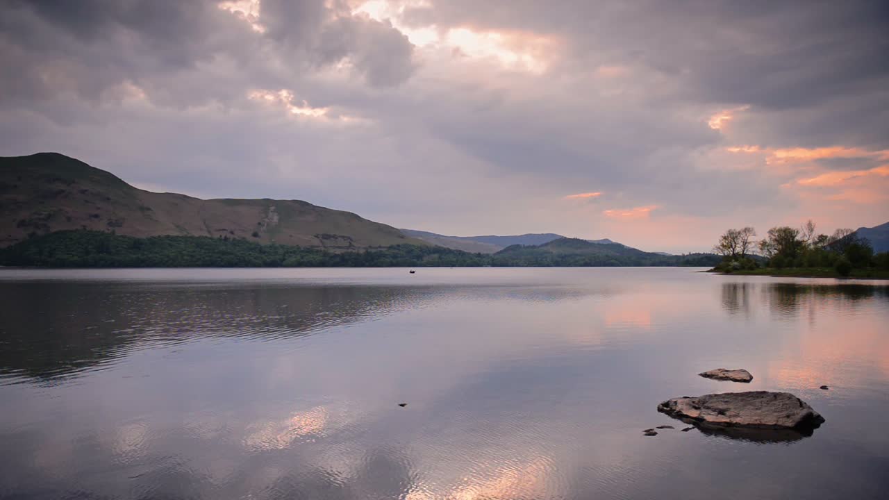 Sunset Over The Serene Lake With Reflections Of Clouds And Mountains On The Water Surface In Lake District, Cumbria, England.- wide shot