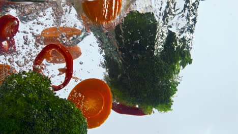 fresh vegetable fall water in super slow motion close up. veggies underwater.