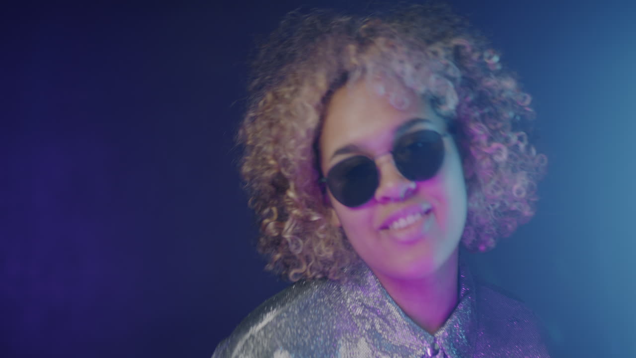 Stylish Woman with Curly Hair and Sunglasses