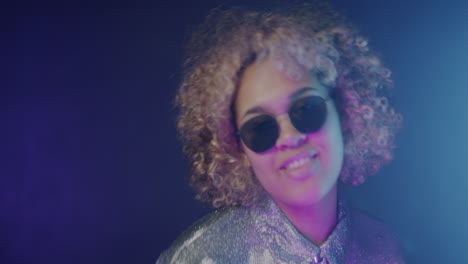 stylish woman with curly hair and sunglasses