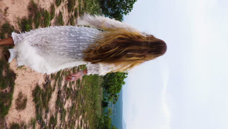 an attractive woman with long healthy hair running towards spectacular nature view