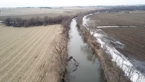 Winter-Time-Aerial-Drone-Video-Of-The-Skunk-River-And-The-Rich-Agricultural-Farmland-Surrounding-Rural-Lynnville,-Iowa