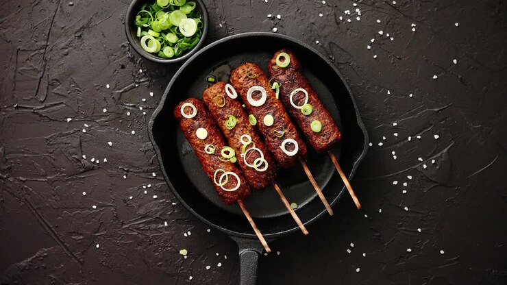 Barbecued turkey kebab decorated with fresh onion