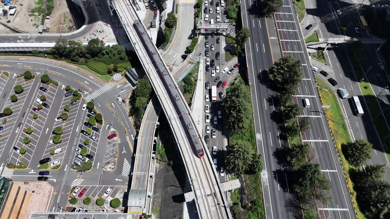 Drone shot of an interurban train departing from Santa Fe station, CDMX