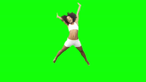 brunette performing a star jump in slow motion