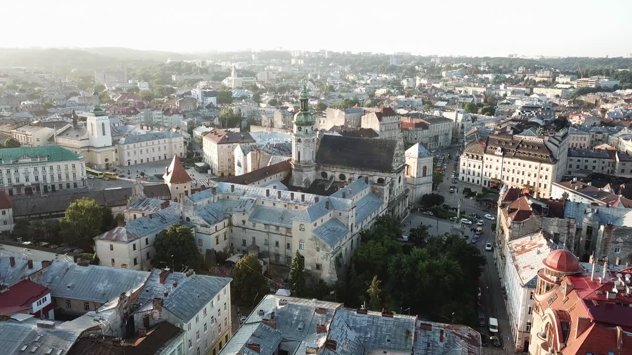 Ukraine, Lviv, Bernardin Church, Drone footage zooms in towards to the church and beyond over the roofs, beautiful city view of towers, old buildings, trees, streets, traffic etc.