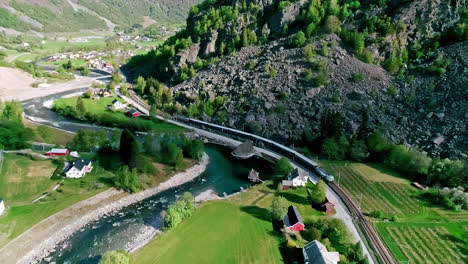 Train-riding-through-majestic-landscape-of-Norway,-Aurland,-aerial-view