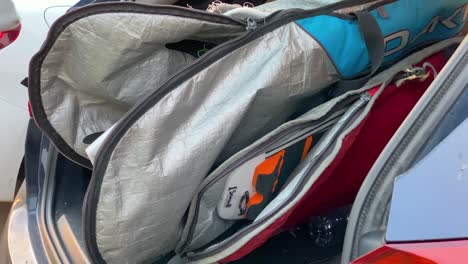 traveling family surfers using surf capes and car bag