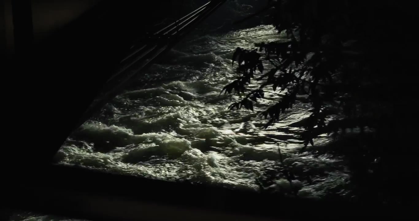 Nighttime flowing river with shadows and reflections in Graz, Austria