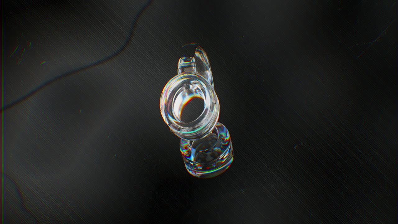 Glass Headphones Rotating with Colorful Light Refraction on Dark Background