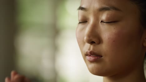 a tranquil moment of reflection: a young individual engages in meditation with eyes closed and hands together, emanating calmness and inner peace