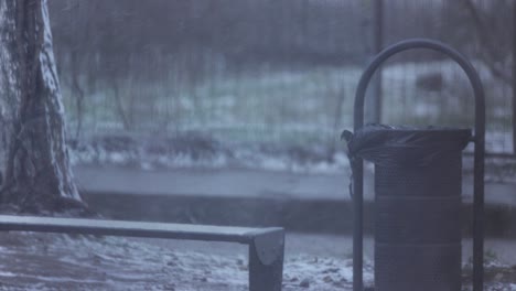 Still-Shot-Of-A-Trash-Bin-On-A-Snowy-Park