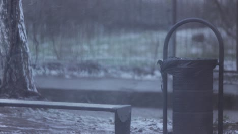 still shot of a trash bin on a snowy park