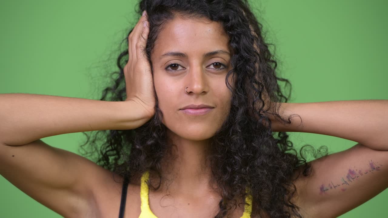 Young beautiful Hispanic woman covering as three wise monkeys concept