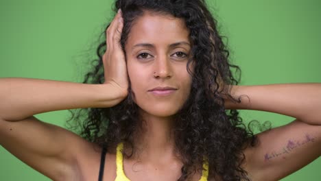 young beautiful hispanic woman covering as three wise monkeys concept