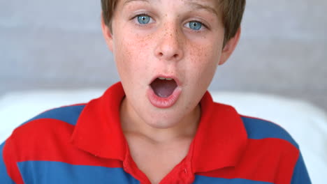 Surprised-blue-eyed-boy-opening-his-mouth-