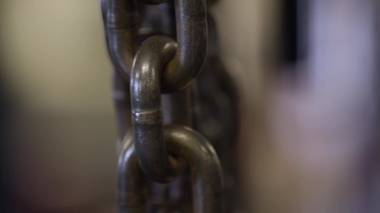 Chains rattling ferociously in fitness center (shallow depth of field)