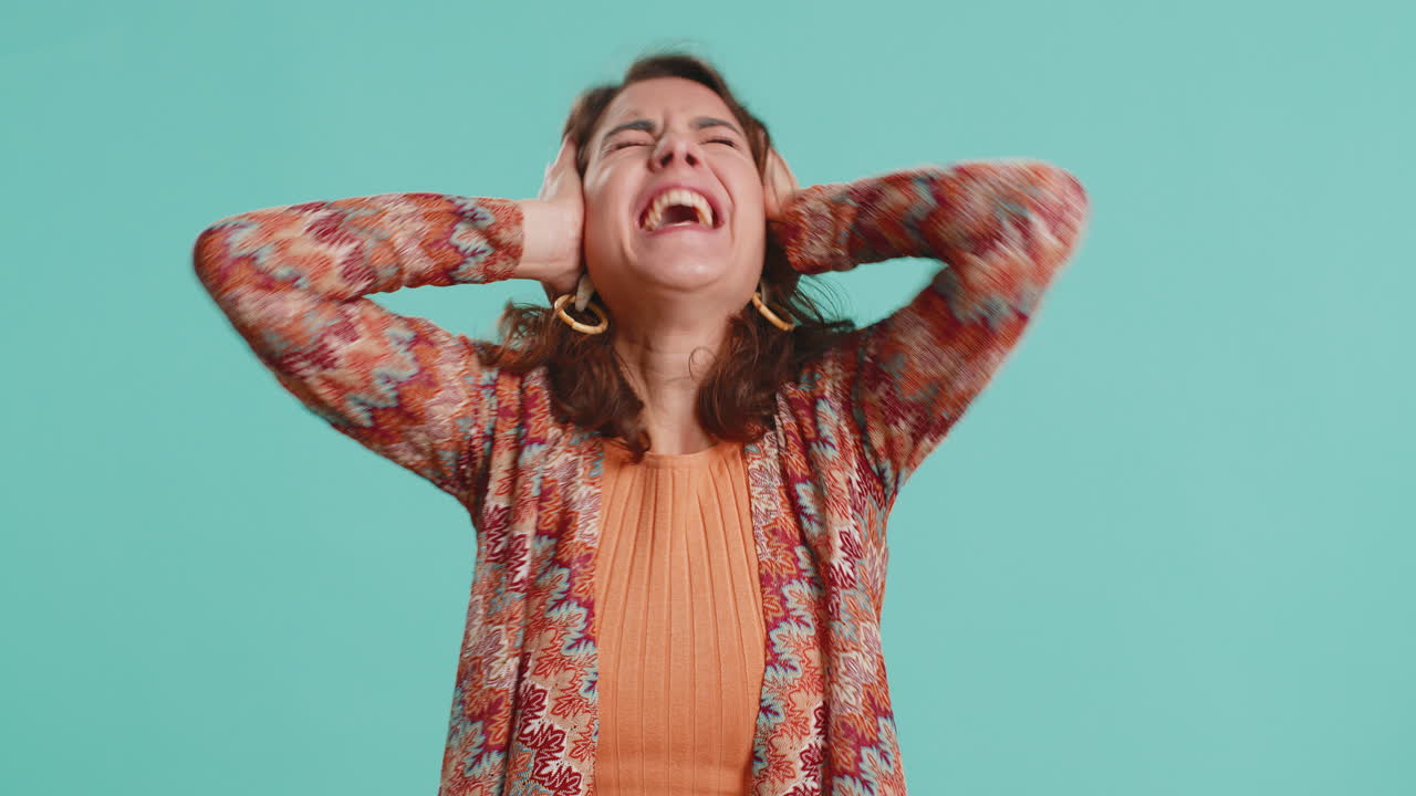 Woman scared fearful covering ears with hands screaming closing eyes meeting own phobia horror