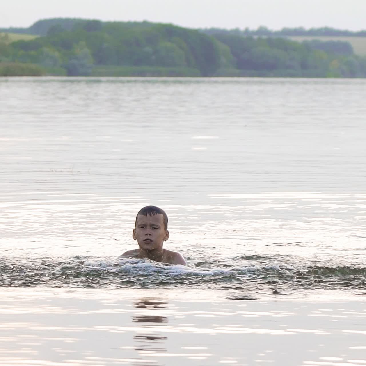 Boy are having fun and splashing in the water. Summer holiday concept. Slow motion.
