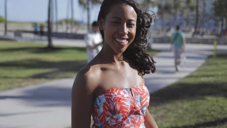 charming black girl in dress laughing at camera