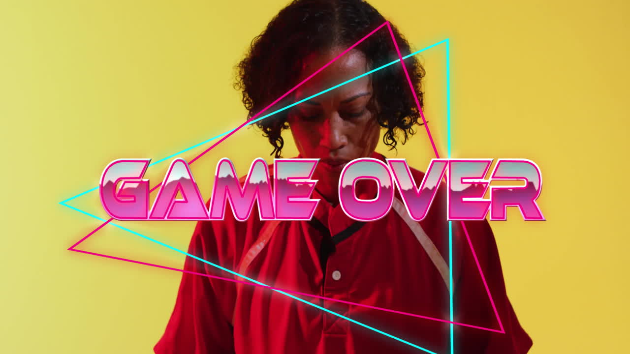 Animation of game over text over african american female rugby player on yellow background