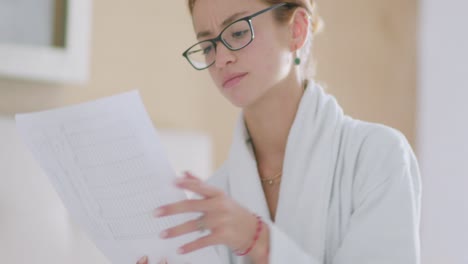 Young lady reading notes on bed