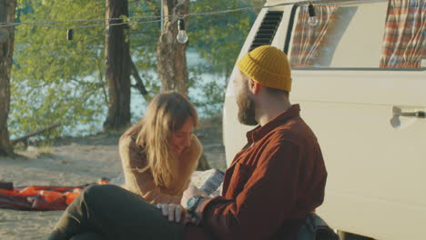 Couple-Talking-by-Van-at-Campsite