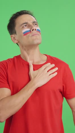 Man listening to the Russia national anthem with solemnity