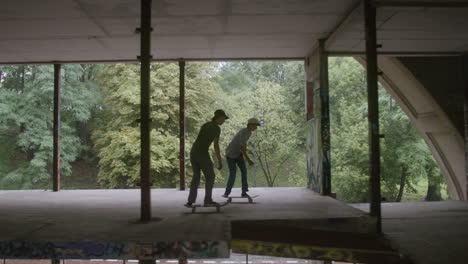 caucasian boys skateboarding in a ruined building.