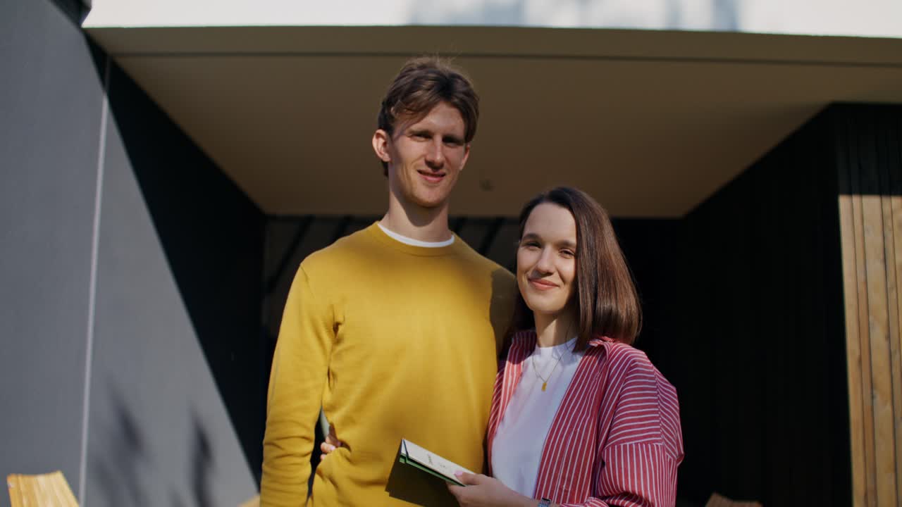 Happy Couple in Front of Modern Home