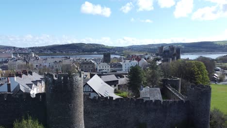 Welsh-holiday-cottages-enclosed-in-Conwy-castle-stone-battlements-walls-aerial-view-slow-push-in-shot