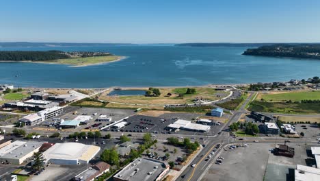 aerial shot pulling away from the oak harbor waterfront with all of the city's shopping amenities in the foreground