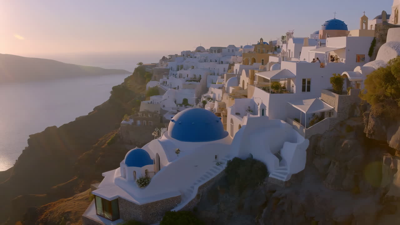 Santorini Sunset: Iconic White Buildings and Blue Domes Overlooking the Aegean Sea