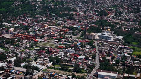 midday drone shot on a sunny day during an approach flight towards the magical town of tepotzotlán, part of the metropolitan area of mexico city