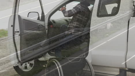 animation of cars on street over disabled caucasian man sitting in wheelchair