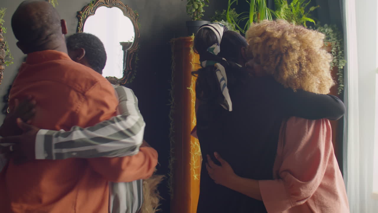 Cheerful African American Couple Greeting Guests at Home