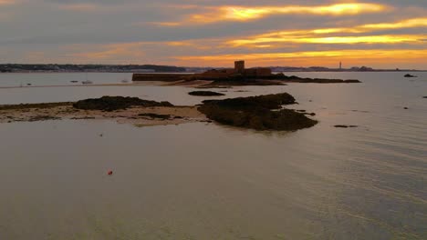 Aerial-Drone-slow-vertical-ascent-looking-towards-St-Aubin's-Fort-in-the-town-of-St-Aubin,-Jersey,-Channel-Islands