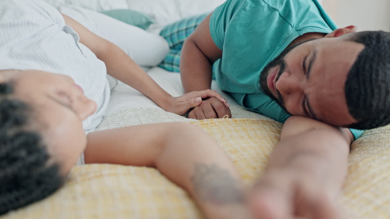 Love, holding hands and couple in bed