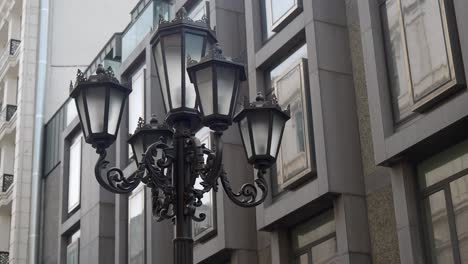 black ornate street lamp in front of modern building