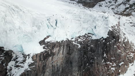 Drone-view-of-the-face-of-a-large-glacier-on-a-sunny-day-in-winter-in-the-Alps