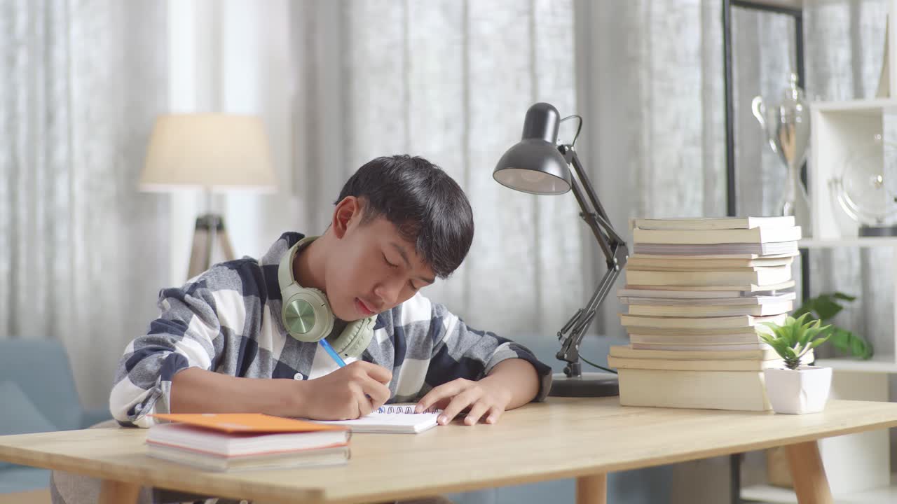 Teenager Yawning While Studying at Home