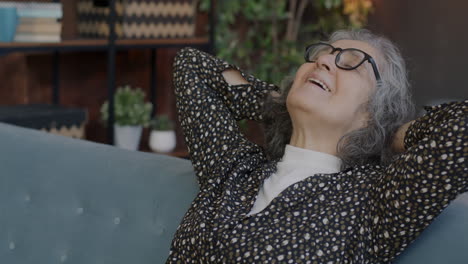 happy senior woman relaxing on a sofa