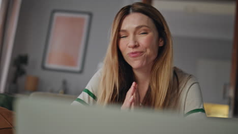 Smiling girl talking online meeting by laptop closeup. Happy woman video calling