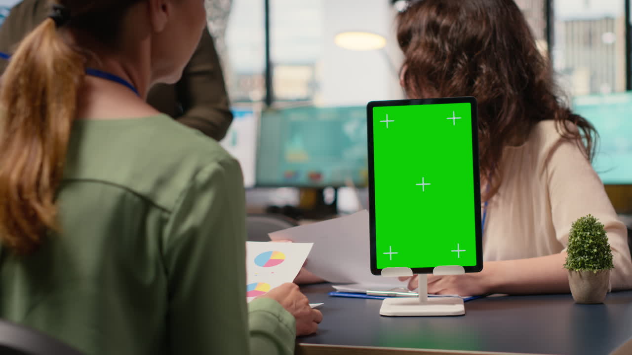 Vertical Video Businesswomen attend meeting in the office with a mockup display