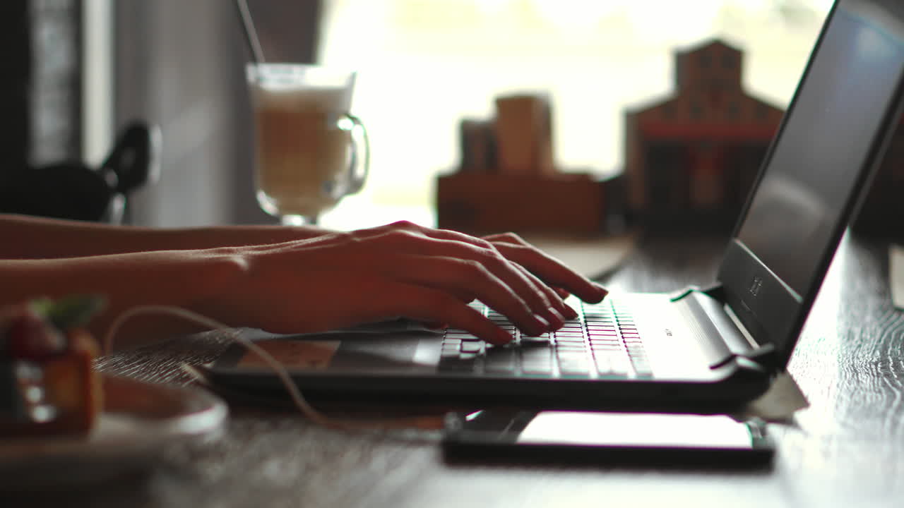 Side profile half-faced photo of busy concentrated smart clever beautiful woman wearing checkered shirt and glasses, she has remote work, typing on laptop and sending emails to clients, soft light