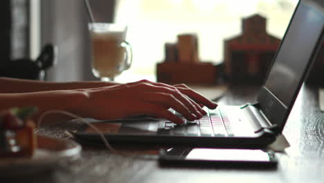 Side-profile-half-faced-photo-of-busy-concentrated-smart-clever-beautiful-woman-wearing-checkered-shirt-and-glasses,-she-has-remote-work,-typing-on-laptop-and-sending-emails-to-clients,-soft-light